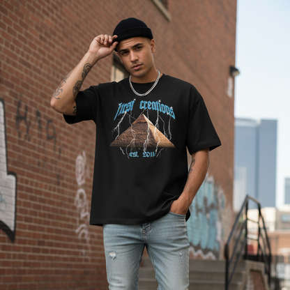 Person wearing a black graphic t-shirt, light blue jeans, and white sneakers in an urban setting.